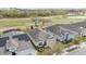 Aerial view of homes near a golf course, highlighting landscaping and a well-maintained community at 7977 Hanson Bay Pl, Kissimmee, FL 34747