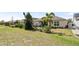 Landscaped backyard with a manicured lawn and mature trees for privacy at 7977 Hanson Bay Pl, Kissimmee, FL 34747