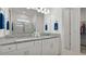 Clean, bright bathroom with double sinks, granite countertops, and a glass-enclosed shower at 7977 Hanson Bay Pl, Kissimmee, FL 34747