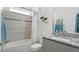 Well-lit bathroom featuring a shower-tub combo, granite vanity, and decorative accents at 7977 Hanson Bay Pl, Kissimmee, FL 34747