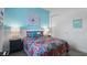 Cozy bedroom featuring a colorful bedspread and a serene ambiance at 7977 Hanson Bay Pl, Kissimmee, FL 34747