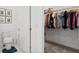 Organized walk-in closet with shelving and rods for ample storage near the toilet at 7977 Hanson Bay Pl, Kissimmee, FL 34747