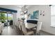 Dining room area featuring modern chandelier and an elegant blue accent wall at 7977 Hanson Bay Pl, Kissimmee, FL 34747