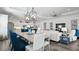 Open concept living and dining area with stylish lighting, comfortable seating, and an inviting atmosphere at 7977 Hanson Bay Pl, Kissimmee, FL 34747