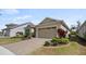 Exterior showcasing a well-kept lawn, attractive landscaping, and a paver driveway at 7977 Hanson Bay Pl, Kissimmee, FL 34747