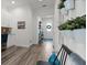 Entryway with wood-look flooring, potted plants, and a view into the home office at 7977 Hanson Bay Pl, Kissimmee, FL 34747