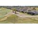 View of a golf course highlighting sand traps with homes nearby, offering a serene and active lifestyle at 7977 Hanson Bay Pl, Kissimmee, FL 34747