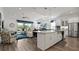 Open concept kitchen and living room featuring island with bar seating and stainless steel appliances at 7977 Hanson Bay Pl, Kissimmee, FL 34747