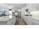Gourmet kitchen boasts white cabinets, stainless steel appliances, and granite countertops at 7977 Hanson Bay Pl, Kissimmee, FL 34747