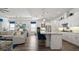 Kitchen view with island and seating opens to living room, creating an airy and inviting space at 7977 Hanson Bay Pl, Kissimmee, FL 34747