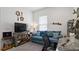 Inviting living room with a comfortable blue sofa and decorative elements at 7977 Hanson Bay Pl, Kissimmee, FL 34747