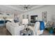 Comfortable living room with a TV, fireplace, and a seamless flow into the modern, well-equipped kitchen at 7977 Hanson Bay Pl, Kissimmee, FL 34747