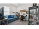 Comfortable living room with a blue sofa, TV, and various decorative items at 7977 Hanson Bay Pl, Kissimmee, FL 34747
