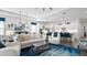 Bright, open-concept living room with plush seating, modern decor, and a seamless flow into the kitchen at 7977 Hanson Bay Pl, Kissimmee, FL 34747