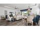 Stylish living room with a view to the outdoors, modern lighting, and comfortable seating for the whole Gathering at 7977 Hanson Bay Pl, Kissimmee, FL 34747