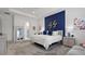 Comfortable main bedroom featuring a blue accent wall, modern decor, and access to an ensuite bathroom at 7977 Hanson Bay Pl, Kissimmee, FL 34747