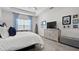 Bright main bedroom with a seating area, carpet floors, and ample space for relaxation and rest at 7977 Hanson Bay Pl, Kissimmee, FL 34747