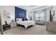 Serene main bedroom with a blue accent wall, a cozy sitting area, and plenty of natural light at 7977 Hanson Bay Pl, Kissimmee, FL 34747