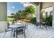 Enjoy the outdoor scenery from this partially covered patio with tables and chairs at 7977 Hanson Bay Pl, Kissimmee, FL 34747