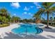 The pool area features palm trees, a tiled deck, and blue waters creating a peaceful and refreshing environment at 7977 Hanson Bay Pl, Kissimmee, FL 34747