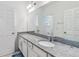Bathroom with a large mirror, granite countertop, and white cabinets and doors at 8255 Bryce Canyon Ave, Windermere, FL 34786