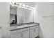 Bright bathroom featuring double sinks, granite countertop, and large mirror at 8255 Bryce Canyon Ave, Windermere, FL 34786