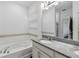 Bathroom showcasing a bathtub, granite countertop, sink and a large mirror at 8255 Bryce Canyon Ave, Windermere, FL 34786