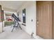 Inviting covered front porch, featuring a porch swing near the home's main entrance at 8255 Bryce Canyon Ave, Windermere, FL 34786