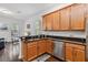 Kitchen featuring stainless steel appliances, granite countertops, and wood cabinets at 8255 Bryce Canyon Ave, Windermere, FL 34786