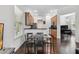 Cozy kitchen featuring wood cabinets, stainless steel appliances and a dining area with hardwood floors and natural light at 8255 Bryce Canyon Ave, Windermere, FL 34786