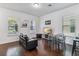 Cozy living room features wood floors, modern furnishings and ample natural light at 8255 Bryce Canyon Ave, Windermere, FL 34786