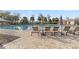 Community pool area featuring multiple lounge chairs and umbrellas for relaxing in the sun at 8255 Bryce Canyon Ave, Windermere, FL 34786