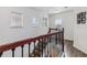 Bright staircase with wood railing and decorative iron spindles leads to the upper level with natural light from the windows at 8255 Bryce Canyon Ave, Windermere, FL 34786
