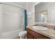 Bright bathroom featuring a shower-tub combination, vanity and mirror at 9122 Stromboli Ct, Kissimmee, FL 34747