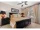 Well-appointed bedroom with black furnishings, soft lighting, and bedside lamps for a tranquil ambiance at 9122 Stromboli Ct, Kissimmee, FL 34747