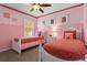Bright pink bedroom with twin beds decorated with a princess theme at 9122 Stromboli Ct, Kissimmee, FL 34747