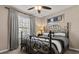 Charming bedroom with a wrought iron bed, curtains, and stylish decor at 9122 Stromboli Ct, Kissimmee, FL 34747