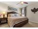Comfortable bedroom features a ceiling fan, decorative prints, and a serene, inviting atmosphere at 9122 Stromboli Ct, Kissimmee, FL 34747