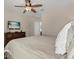 Relaxing bedroom with ceiling fan, television, chest of drawers, and neutral color palette at 9122 Stromboli Ct, Kissimmee, FL 34747