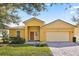 Charming single-story home featuring a brick driveway, manicured lawn, and neutral-toned facade at 9122 Stromboli Ct, Kissimmee, FL 34747