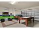 Spacious game room featuring foosball, pool table, TV, fan, and comfortable seating area at 9122 Stromboli Ct, Kissimmee, FL 34747