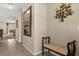 Well-lit hallway with bench seating, a mirror, and decorative wall art at 9122 Stromboli Ct, Kissimmee, FL 34747