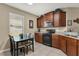 Functional kitchen featuring black appliances, ample counter space, and a cozy breakfast nook at 9122 Stromboli Ct, Kissimmee, FL 34747