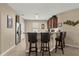 Kitchen with bar seating, stainless steel refrigerator, and ample counter space at 9122 Stromboli Ct, Kissimmee, FL 34747