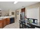 Bright kitchen features stainless steel refrigerator and dark wood cabinets, with adjacent dining area at 9122 Stromboli Ct, Kissimmee, FL 34747