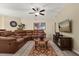 Cozy living room with leather sofa, accent rug, and entertainment center for relaxed living at 9122 Stromboli Ct, Kissimmee, FL 34747