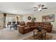 Spacious living room with comfortable leather seating, ceiling fan, and adjacent dining area at 9122 Stromboli Ct, Kissimmee, FL 34747