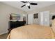 Relaxing main bedroom showcasing a ceiling fan, TV and ensuite bathroom at 9122 Stromboli Ct, Kissimmee, FL 34747