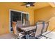 Covered patio features a table and six chairs, ideal for outdoor dining and relaxation at 9122 Stromboli Ct, Kissimmee, FL 34747