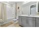 Neutral bathroom featuring tub/shower combo, gray vanity, and neutral color palette at 9947 Summerlake Groves St, Winter Garden, FL 34787